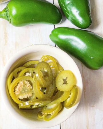 white ramekin with pickled jalapeno peppers