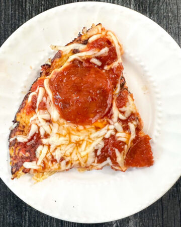 spaghetti squash pizza slice on white plate