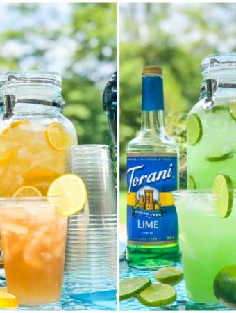 Spiked Iced tea and Margarita punch in large containers with Torani bottles, cups and sliced fruit outside